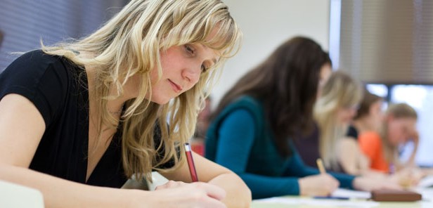 Students writing in class.